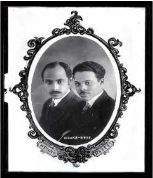 An old black and white photo of two men in suits.