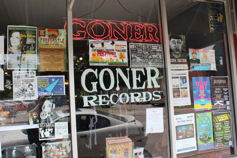 A storefront with a sign that says goner records is a record store in Memphis.