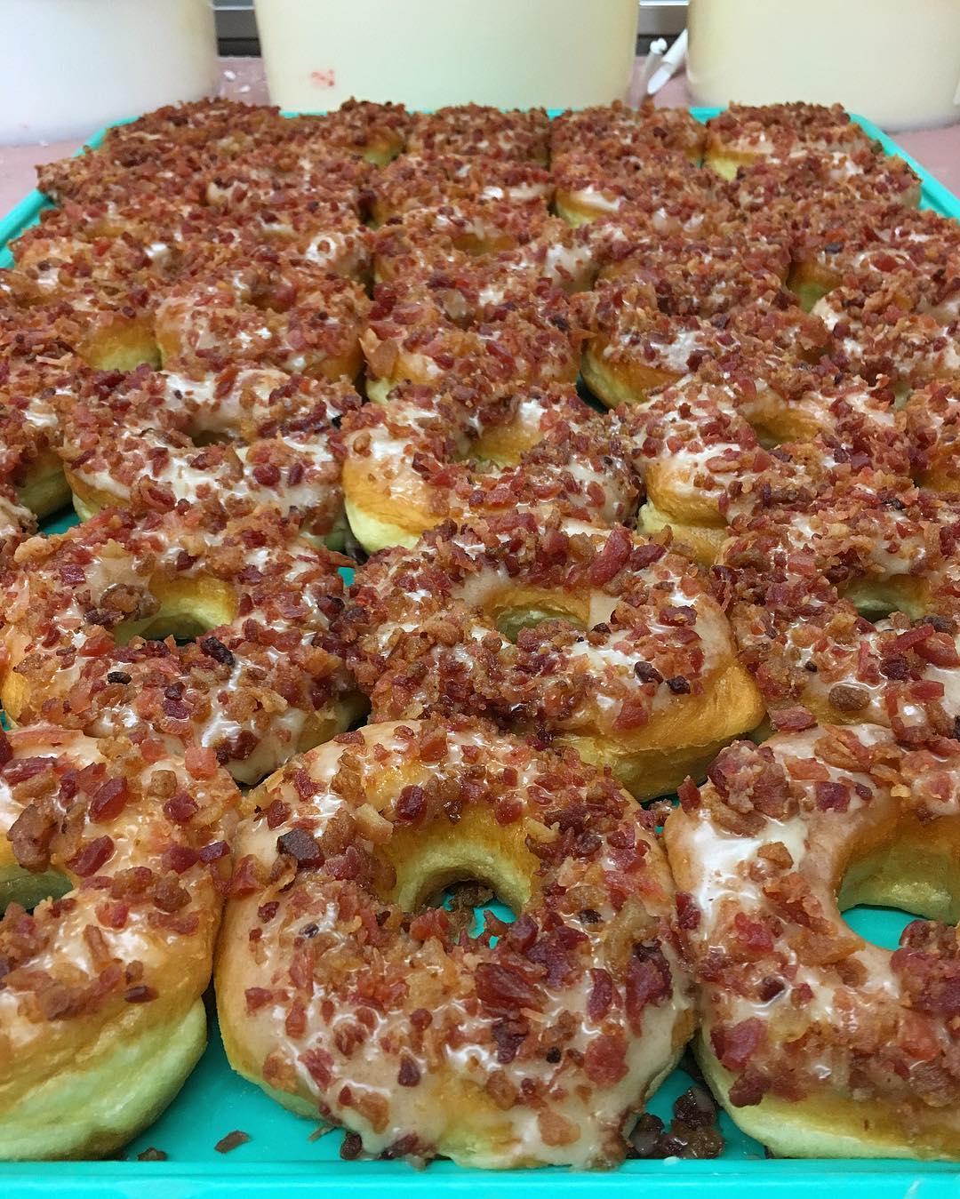 Late night bites: A tray full of donuts covered in bacon.