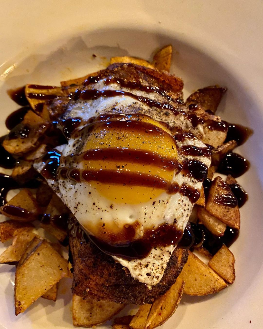 Late night bites: A plate with a fried egg and fries, perfect for a midnight snack.