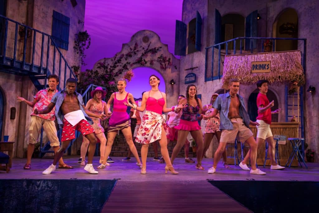 A group of people performing Abba's hits on stage in Mamma Mia!