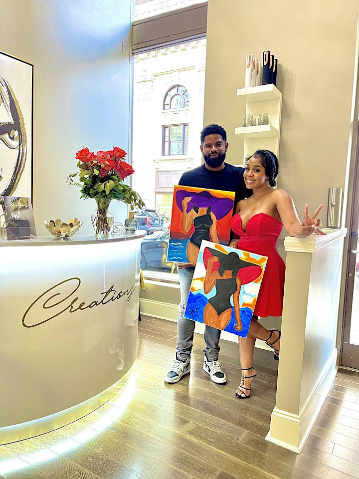 Two people posing in front of a painting on Valentine's Day in Memphis 2020 at a salon.