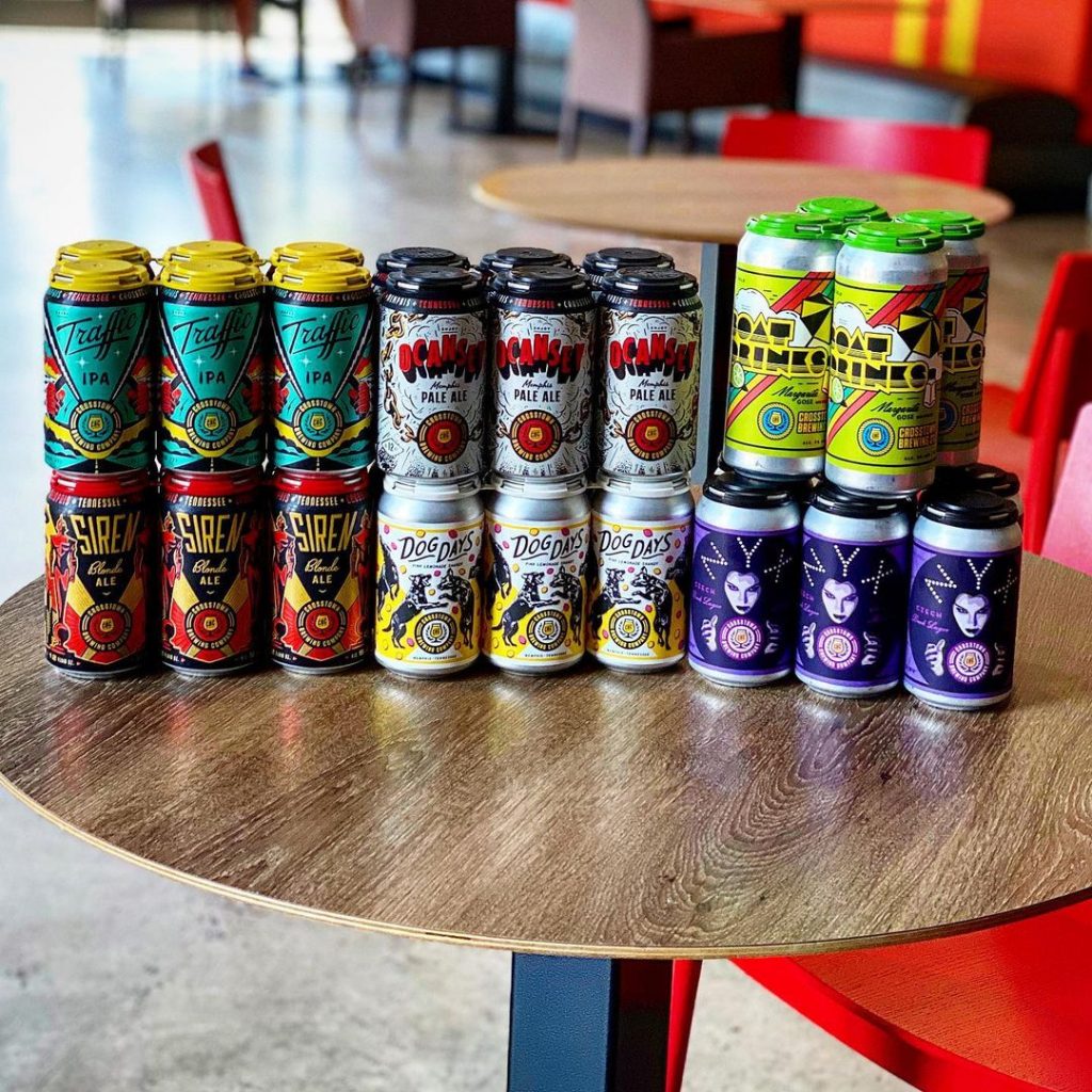 A group of brewery cans sitting on a table.