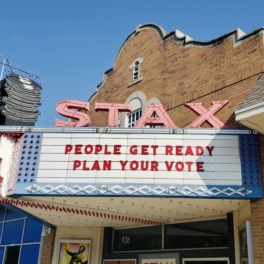 A movie theater with a sign that says stax people get ready plan your vote.