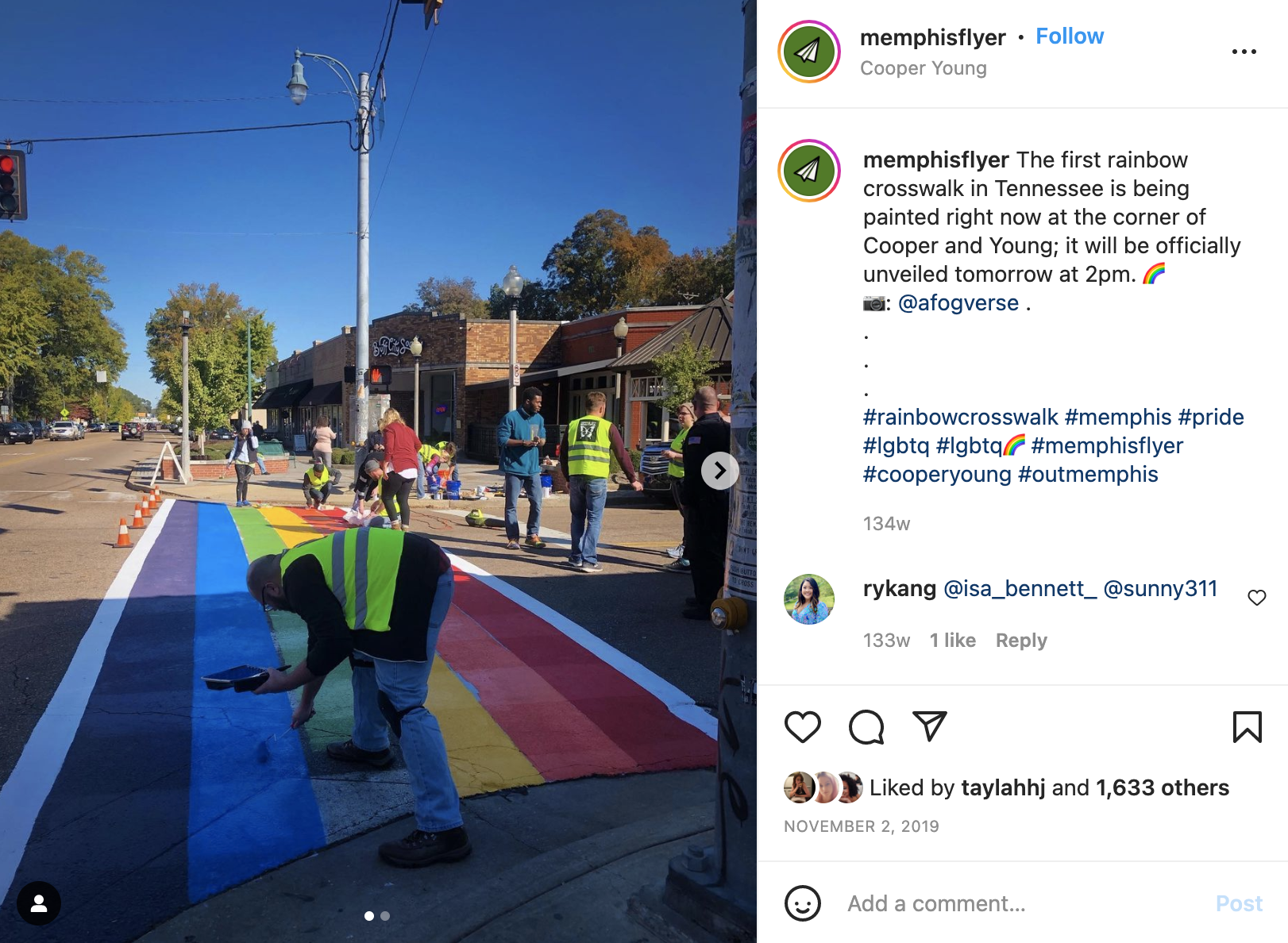 A group of Memphis LGBTQ+ individuals are working on a street with a rainbow painted on it.
