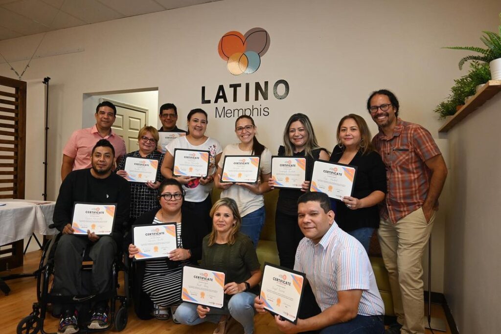 A Latinx community in Memphis celebrating their achievements with a group photo.