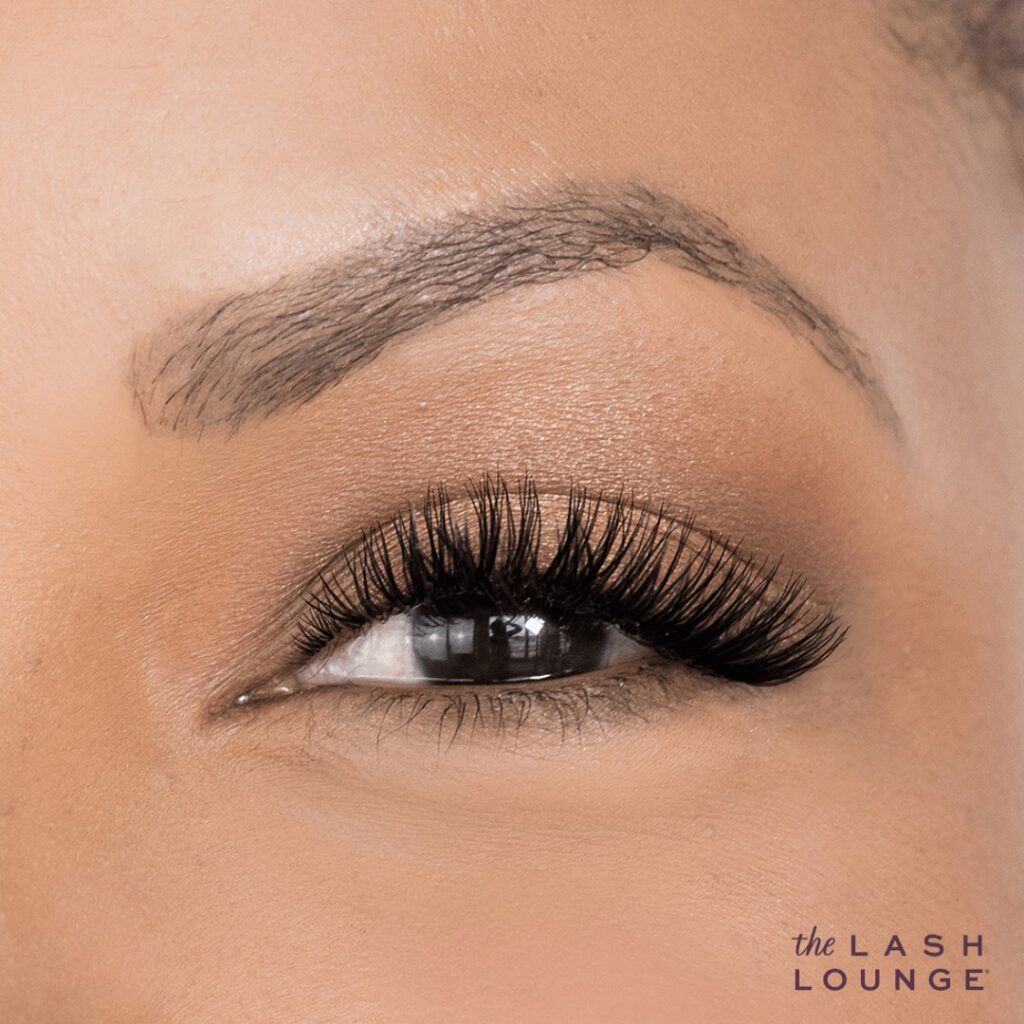 A woman's eye with lashes on it, highlighting the enchanting results of self-care services in Memphis.