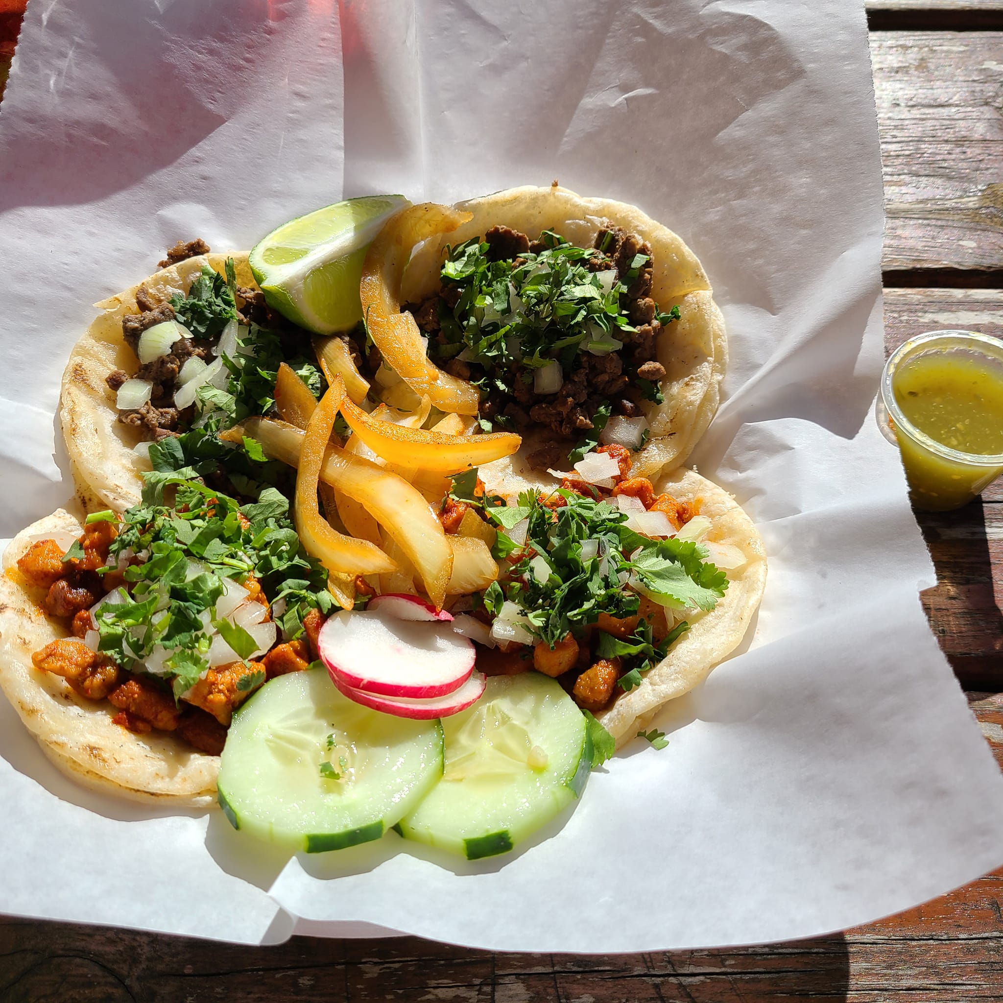 Tacos on a wooden table.