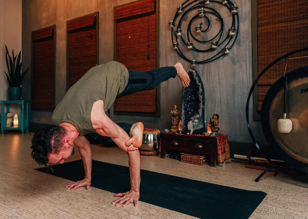 A man doing a handstand in a yoga studio in Memphis, Tennessee.