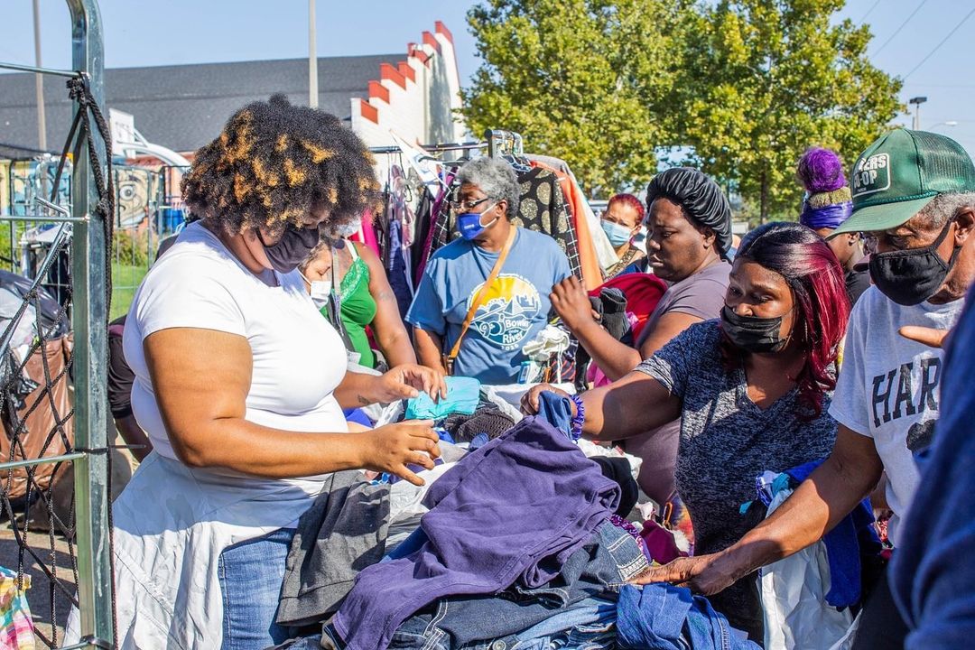 A group of people shopping for clothes at an outdoor market in Memphis.