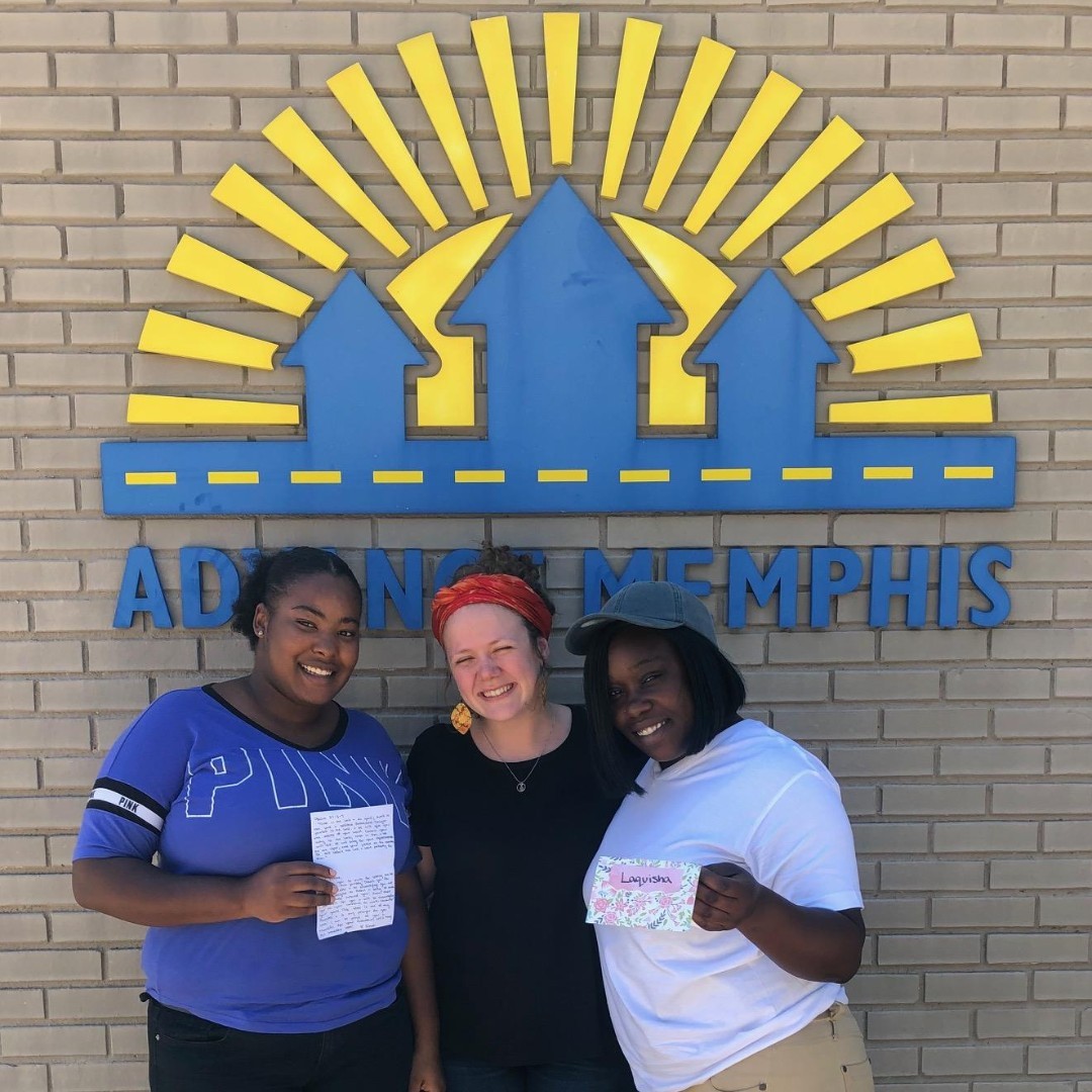 Three girls standing in front of a sign that says ada in Memphis while supporting local nonprofits.