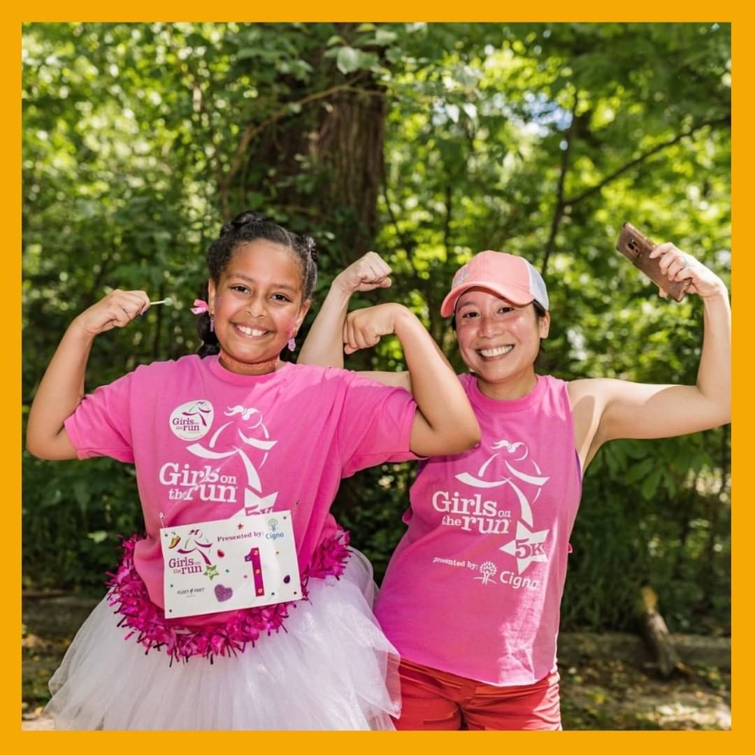 Two girls in pink t-shirts posing for a photo at a Memphis nonprofit event.