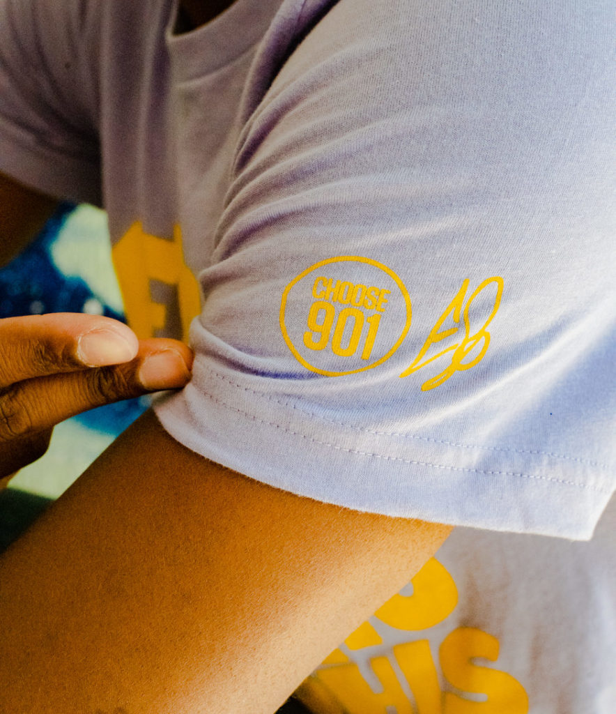A person wearing a t-shirt with an Eso Tolson designed logo.