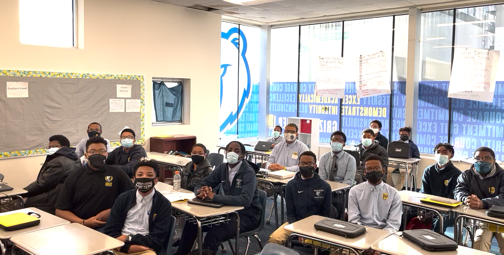 A group of students in a classroom wearing face masks.