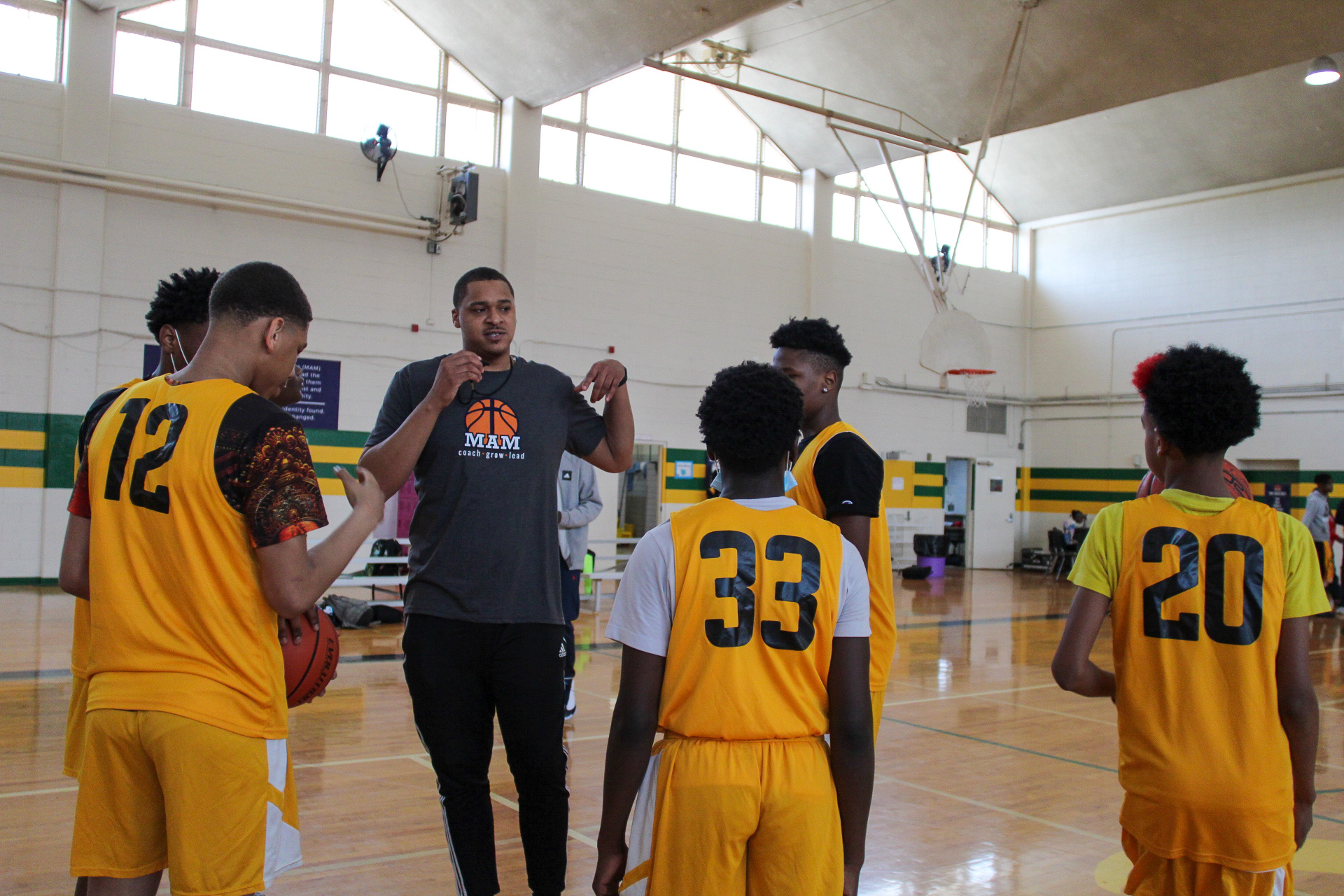 A group of basketball players from Memphis Athletic Ministries standing in a gym.