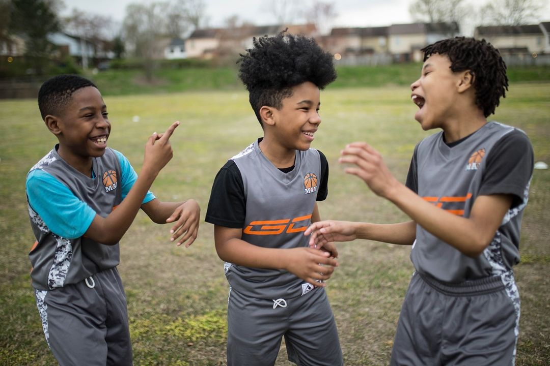 Chalkbeat's Annual Summer Camp Guide is Here with Three young boys playing soccer in a field.
