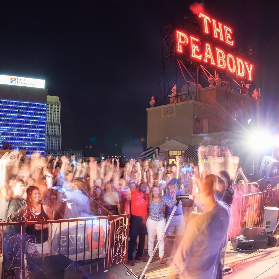 A crowd of people at a Peabody Rooftop Party.