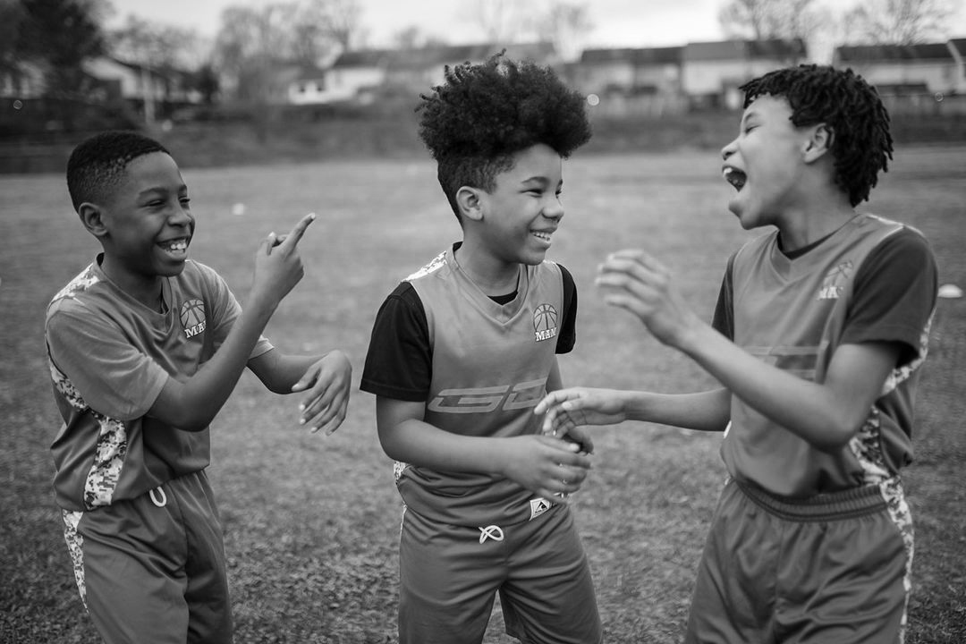 Give901 Summer Camp participants laughing on a soccer field.
