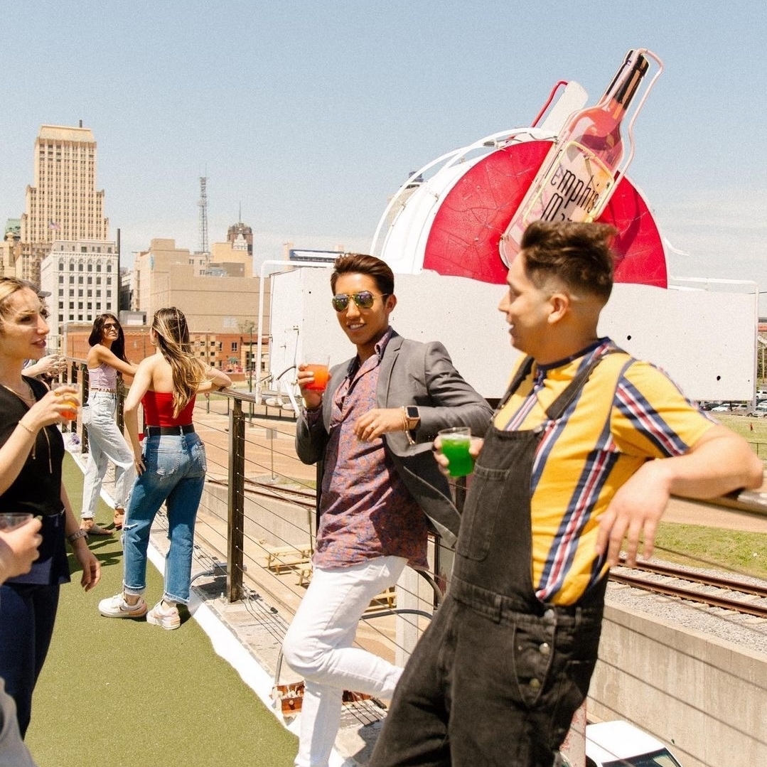 A group of people enjoying drinks on a rooftop.