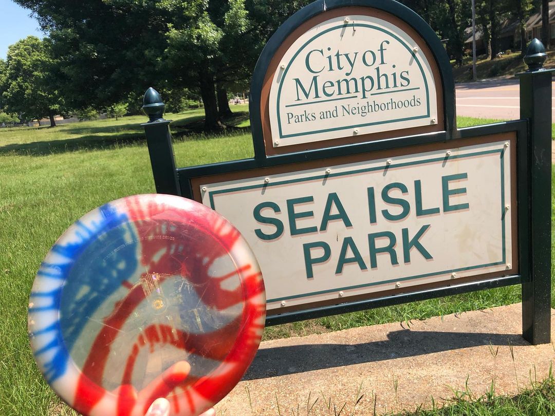 American flag disc in front of sign at disc golf course in Memphis.