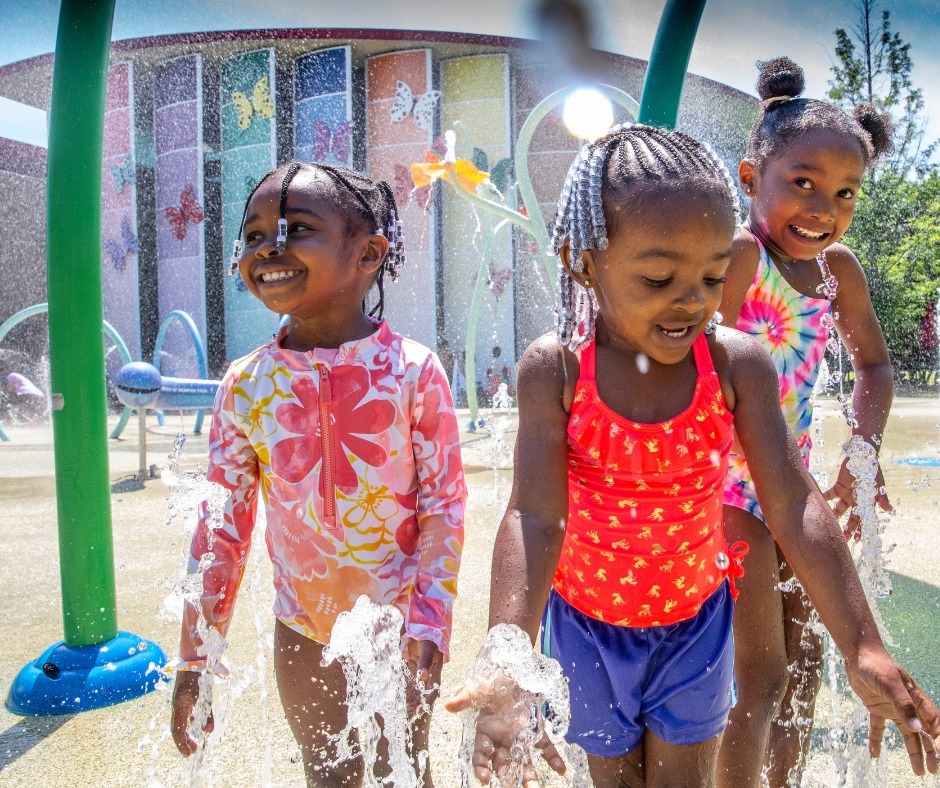 Three young girls having fun a Memphis Splash Pad at Children's Museum of Memphis