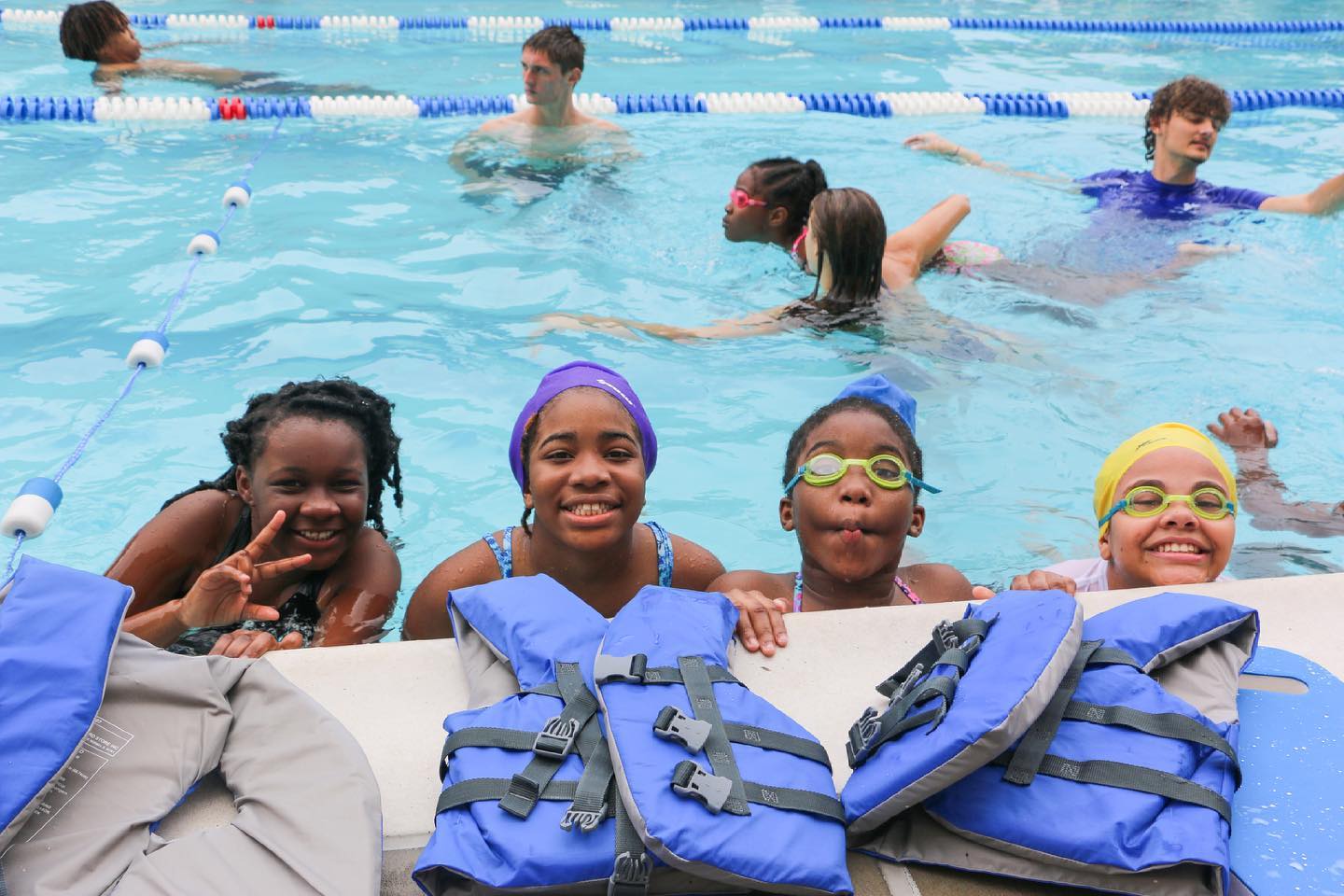 Four young girls receive swimming lessons at Memphis YMCA pool