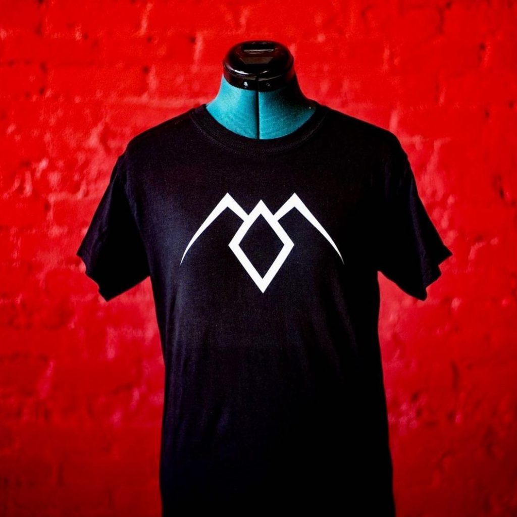 A black t - shirt with a white logo on it.