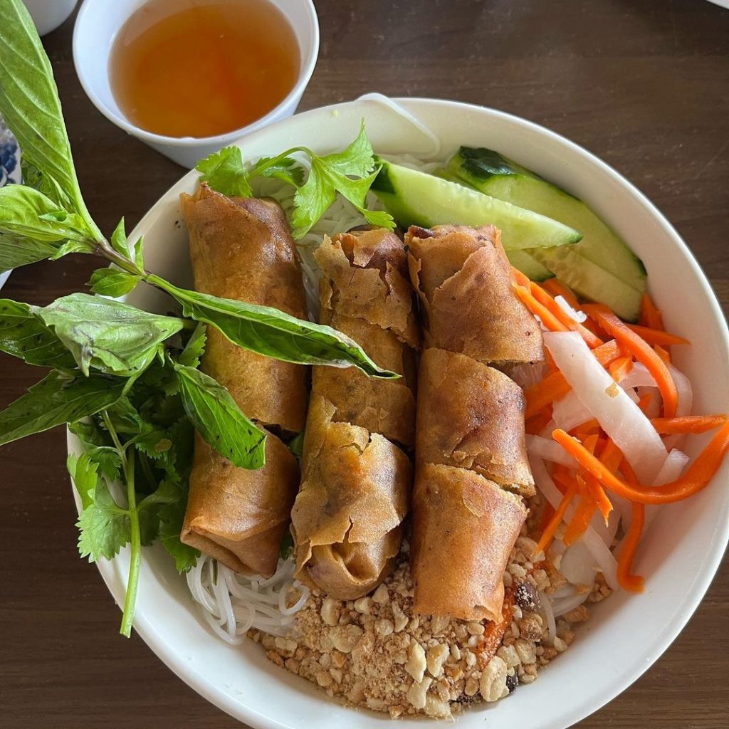 Vietnamese spring rolls in a bowl on a table.
