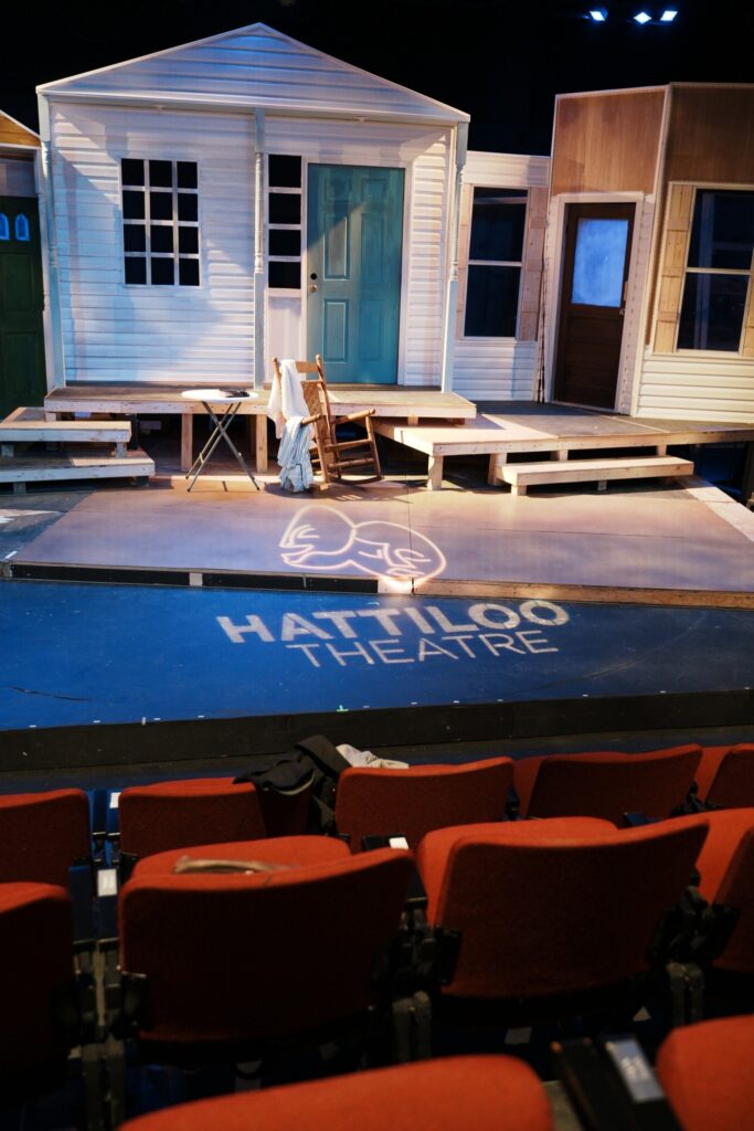 A stage with chairs and a Memphis-themed set for live theatre.