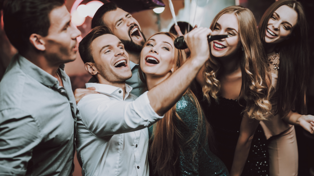 A group of friends having karaoke fun at a local nightclub.