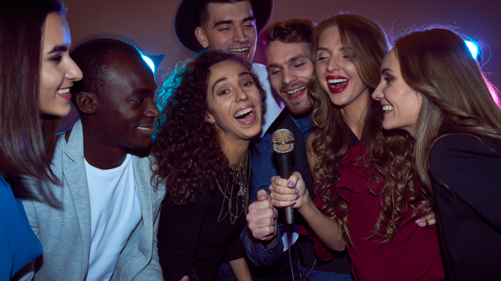 A group of people singing together at a Karaoke Hot Spot party in Memphis.