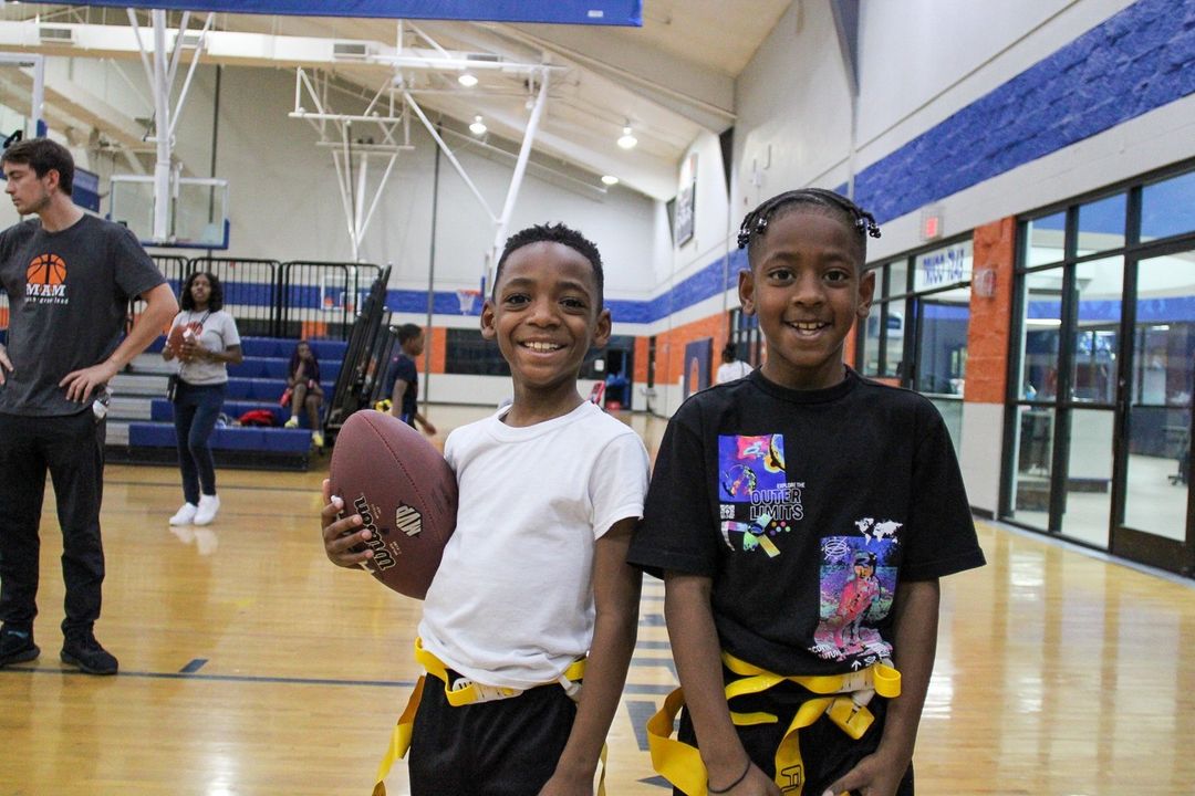 Two young boys posing for a photo at the MAM Center.