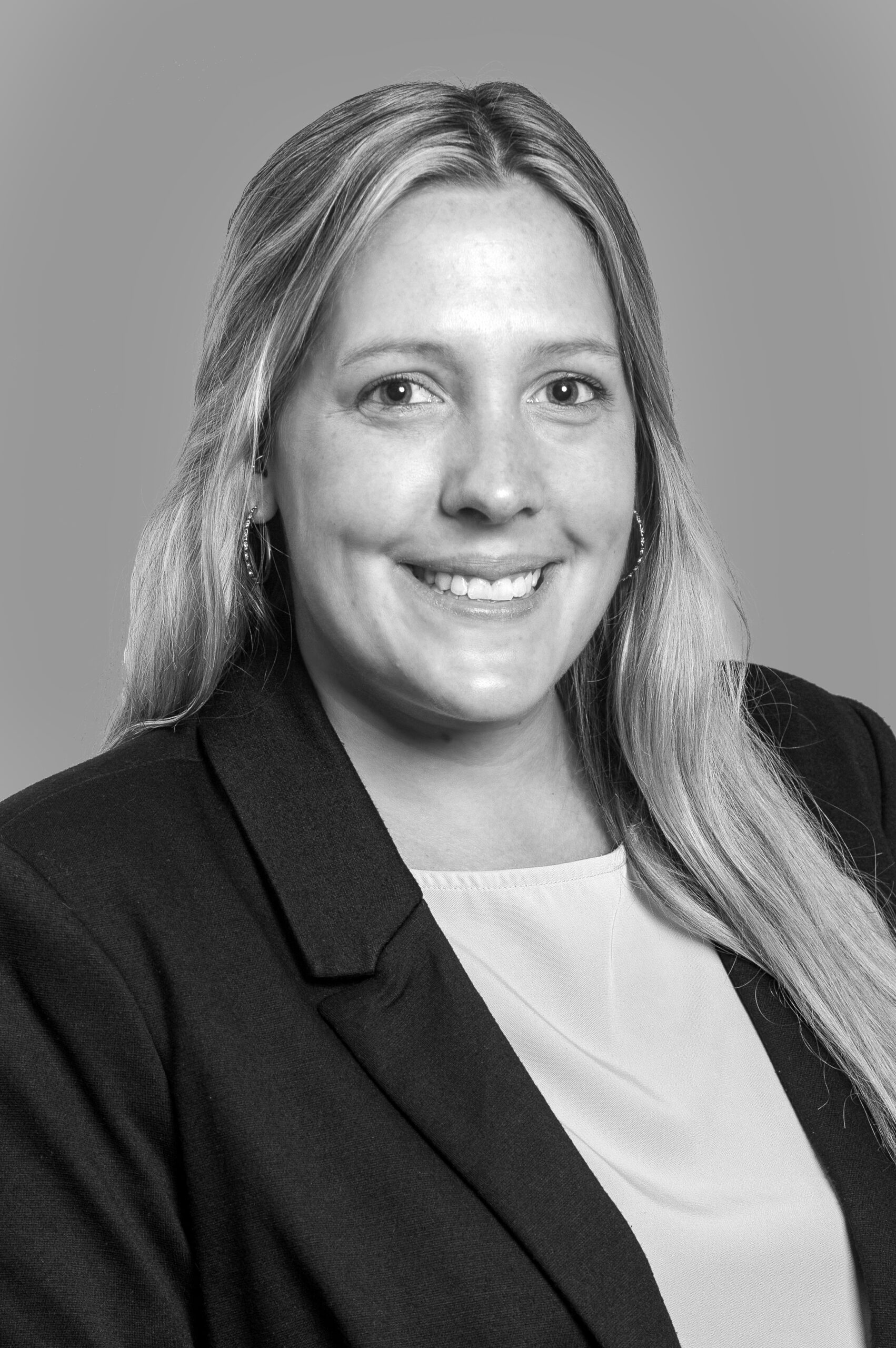 A black and white photo of a woman in a business suit exemplifying mentorship.