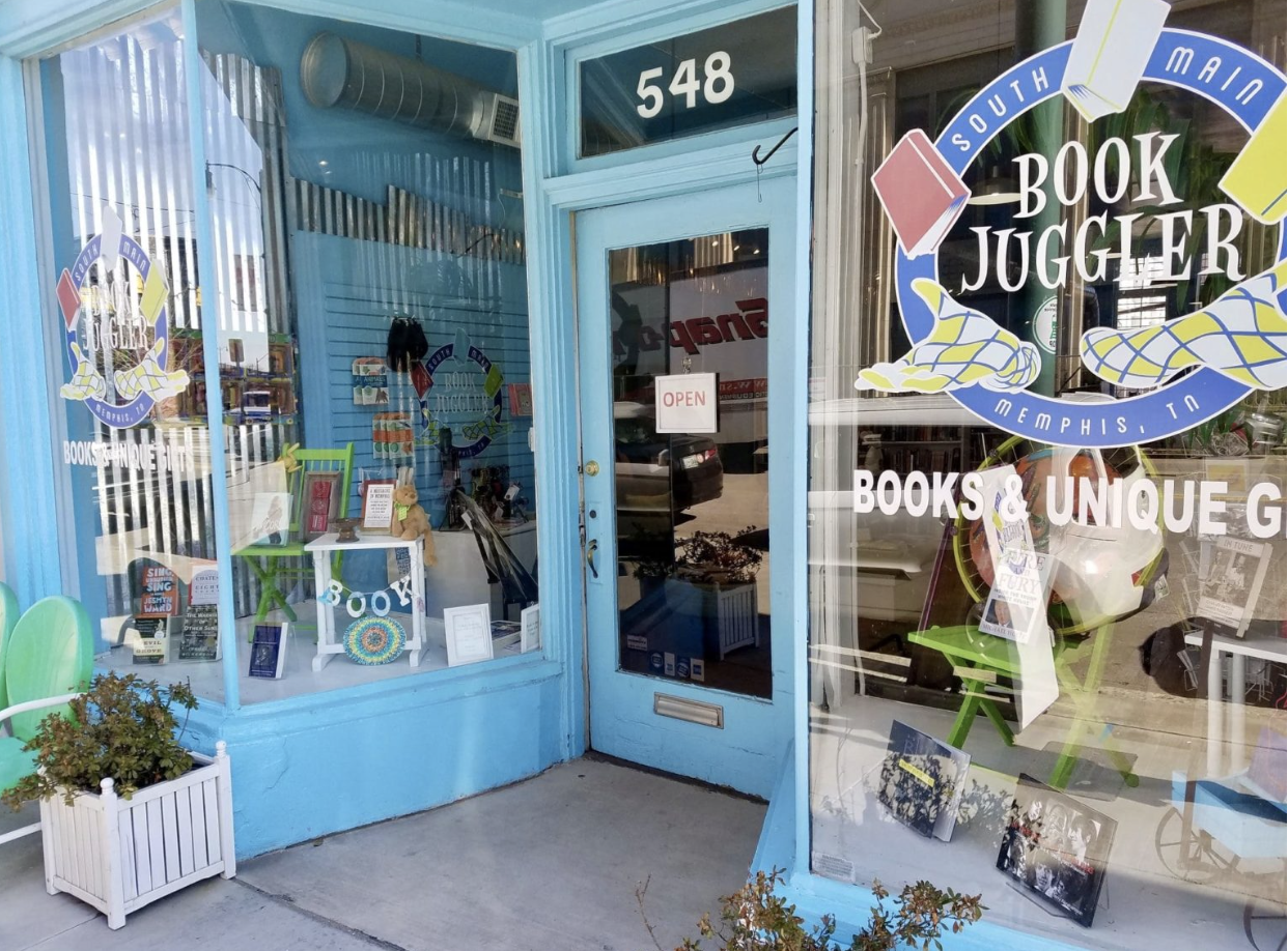 A blue storefront promoting summer learning with a sign that says book jogger.