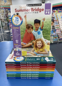 A stack of summer learning books in a store.