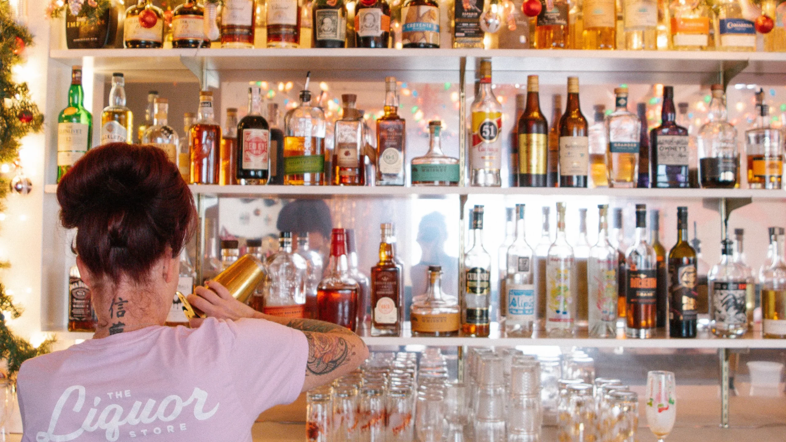A woman pouring a drink at a pop-up bar.