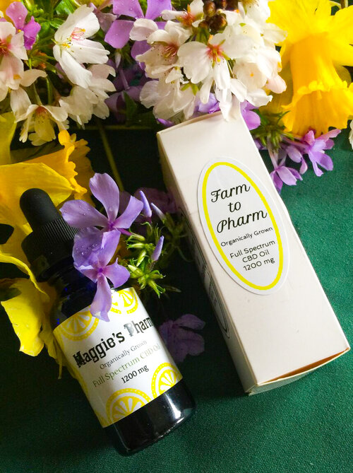 A festive bottle of farm phrym with flowers next to it, perfect for the holiday season.