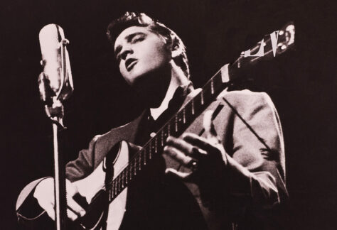 Elvis Presley performing with an acoustic guitar during Elvis Week.