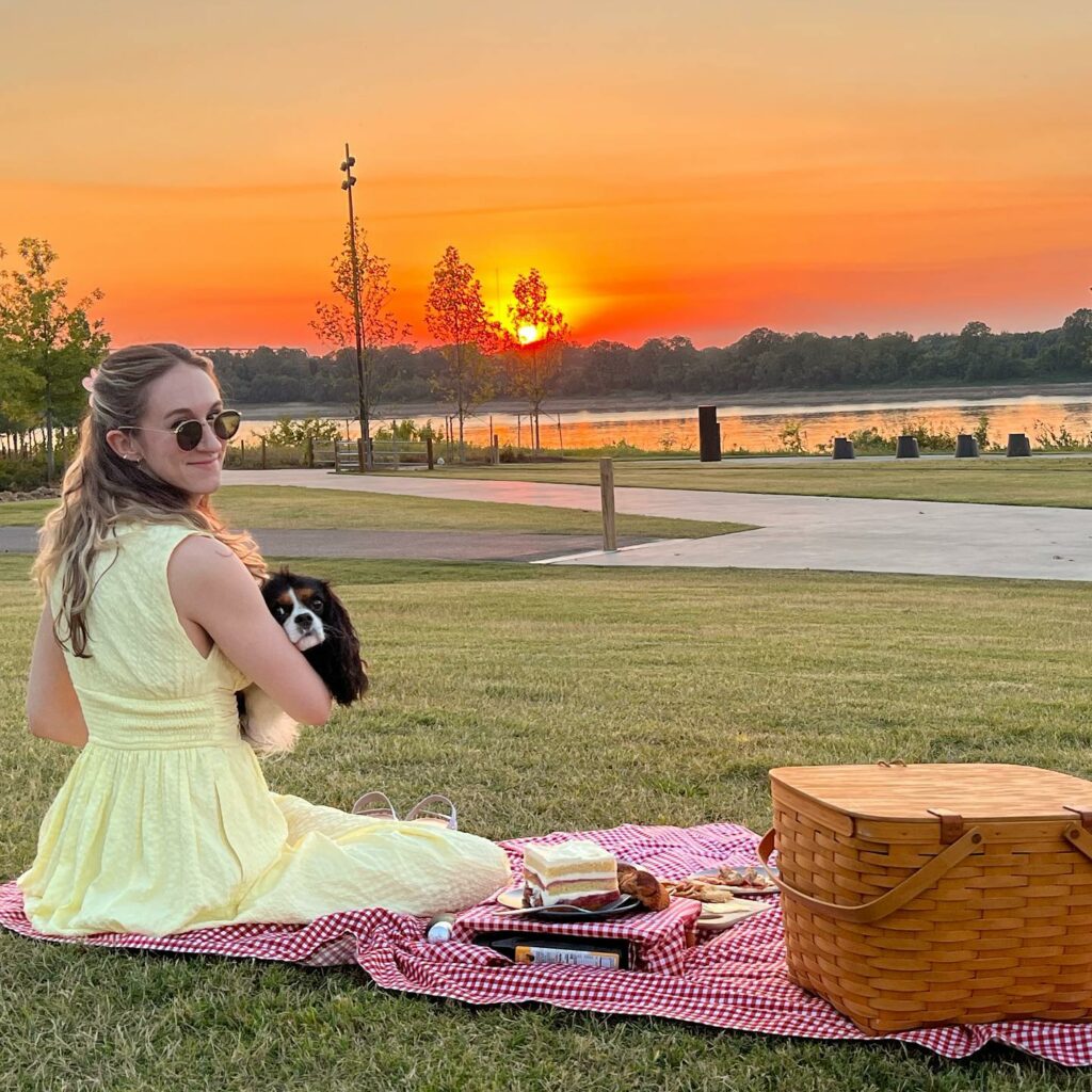 Woman with a dog enjoying a picnic during a solar eclipse in Memphis.